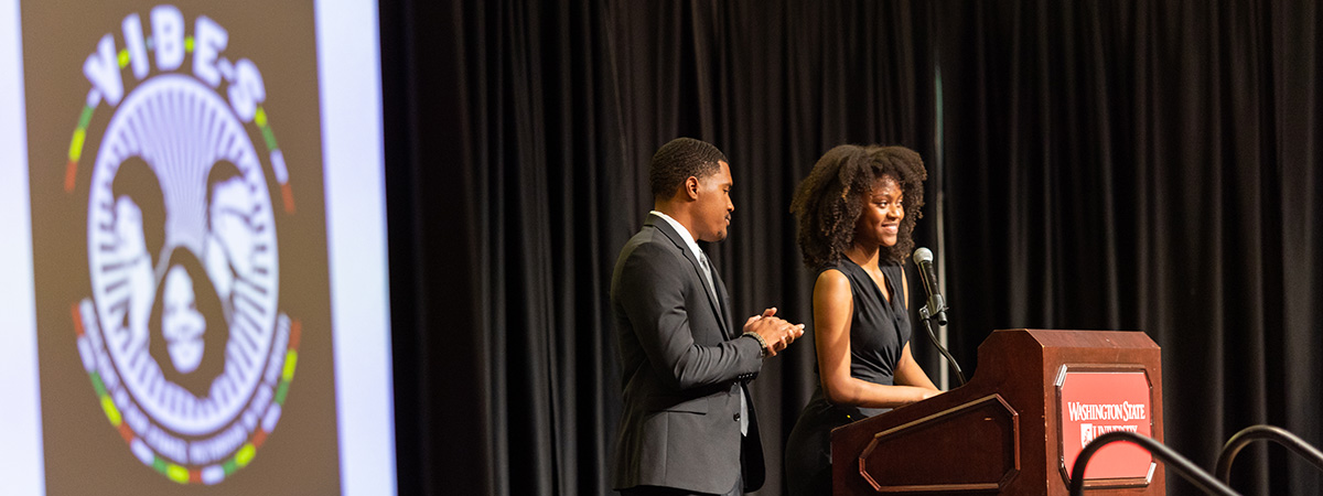 students speaking at multicultural fundraiser banquet